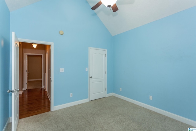 unfurnished bedroom with ceiling fan, high vaulted ceiling, and light carpet