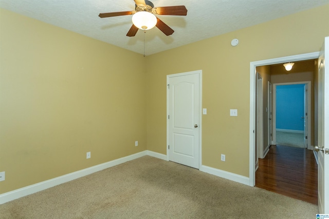 unfurnished bedroom featuring ceiling fan and carpet flooring