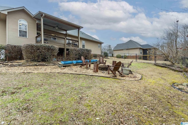 view of yard featuring ceiling fan and an outdoor fire pit