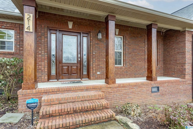 view of exterior entry with covered porch