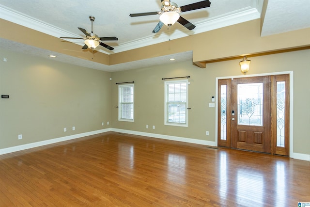 foyer entrance with crown molding, ceiling fan, and hardwood / wood-style flooring