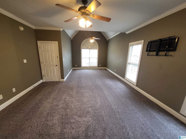 carpeted spare room featuring crown molding, vaulted ceiling, and a wealth of natural light