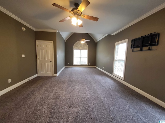 unfurnished room featuring lofted ceiling, ornamental molding, and a healthy amount of sunlight