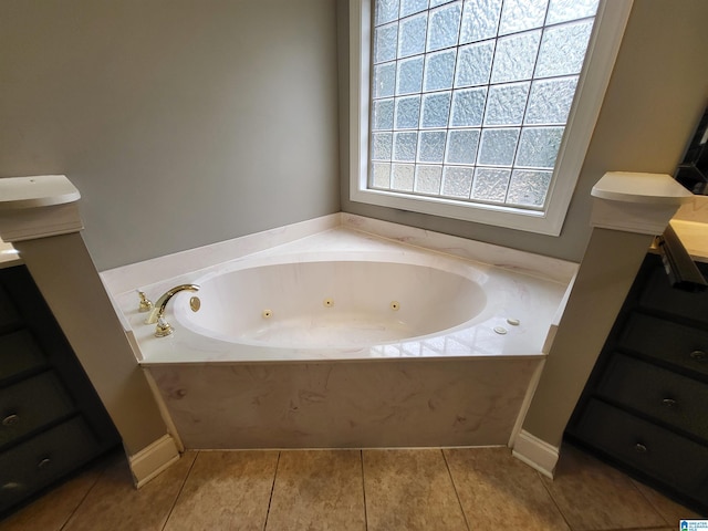 bathroom featuring tile patterned floors and a bath