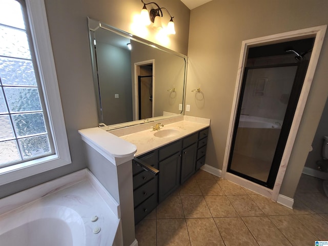 bathroom with vanity, tile patterned floors, and shower with separate bathtub