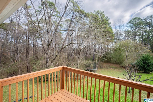 deck with a trampoline and a yard