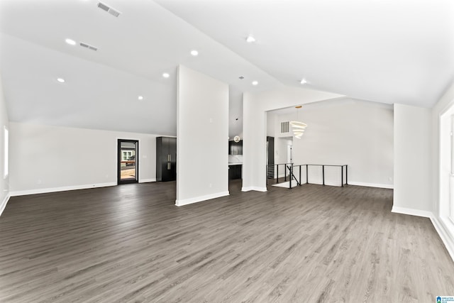 unfurnished living room featuring lofted ceiling and hardwood / wood-style flooring