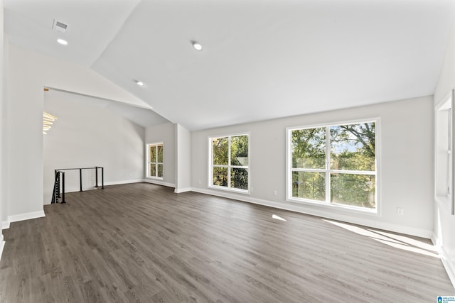 unfurnished living room featuring lofted ceiling and dark hardwood / wood-style floors