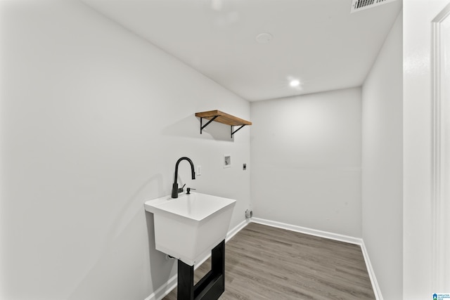 laundry area featuring wood-type flooring, hookup for an electric dryer, and washer hookup