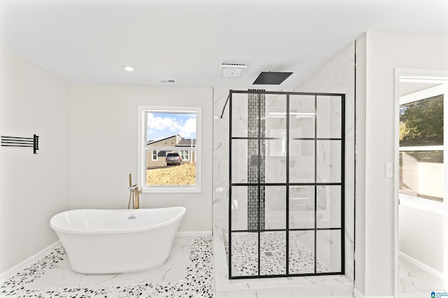 bathroom featuring shower with separate bathtub