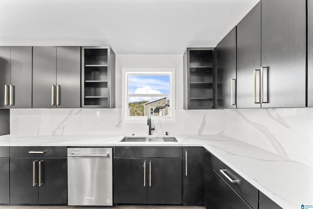 kitchen with tasteful backsplash, sink, and light stone counters