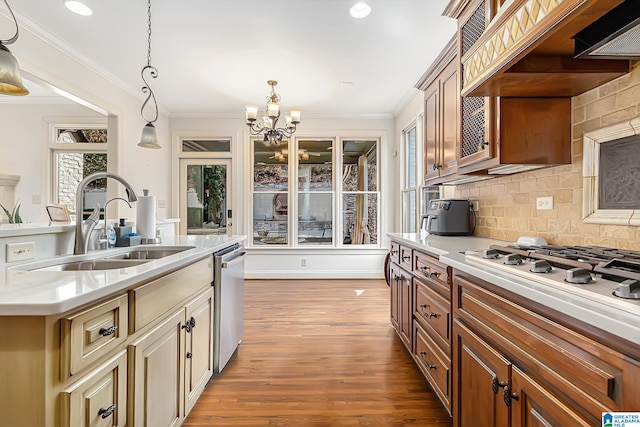 kitchen featuring sink, hardwood / wood-style flooring, dishwasher, hanging light fixtures, and custom range hood