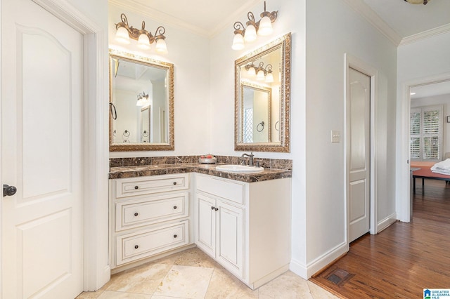 bathroom featuring crown molding and vanity