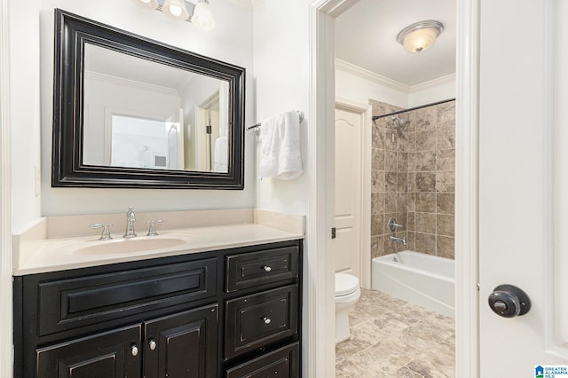 full bathroom with crown molding, tiled shower / bath, vanity, and toilet