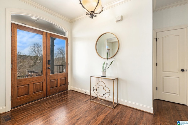 entryway featuring crown molding, dark hardwood / wood-style floors, a chandelier, and french doors