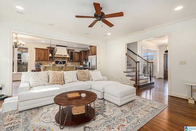 living room with crown molding, ceiling fan, and dark hardwood / wood-style flooring