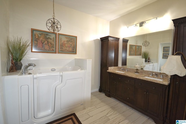 bathroom with vanity and a washtub