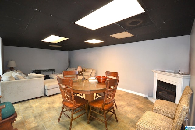 dining area with a paneled ceiling