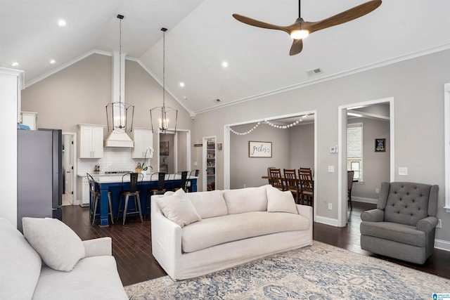 living room with dark wood-type flooring, ceiling fan, crown molding, and vaulted ceiling