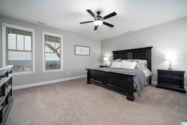 bedroom with ceiling fan and light colored carpet