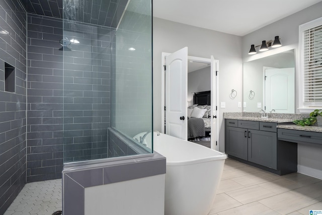 bathroom with vanity, tile patterned flooring, and tiled shower