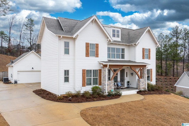 view of front of property featuring a garage, central AC, and a porch