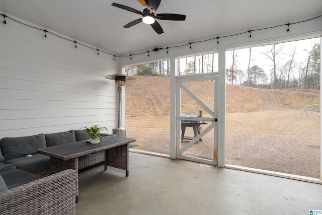 sunroom / solarium featuring ceiling fan