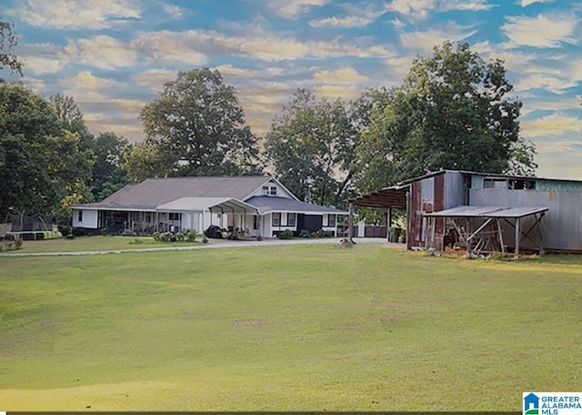 exterior space with a carport and a yard