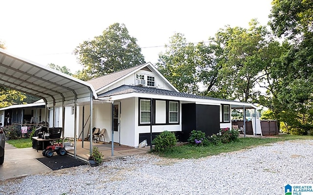 view of front of home with a jacuzzi and a carport