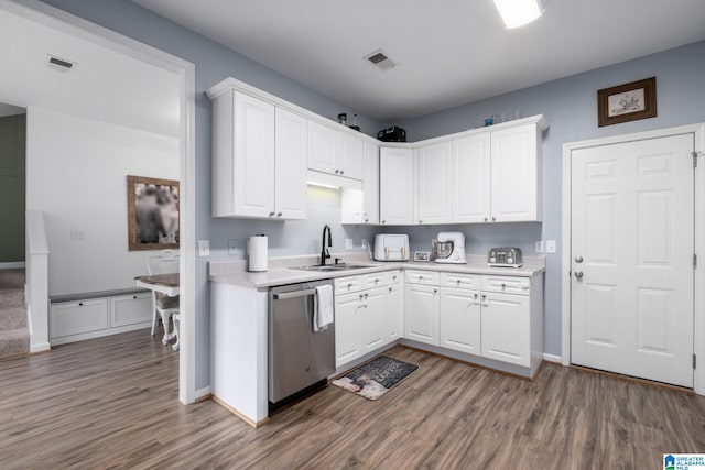 kitchen featuring white cabinetry, dark hardwood / wood-style flooring, and stainless steel dishwasher