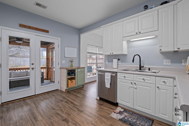 kitchen with dark hardwood / wood-style floors, white cabinetry, dishwasher, sink, and french doors