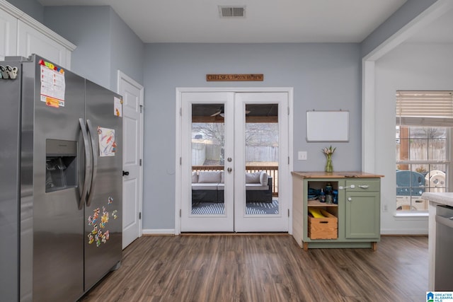 kitchen with french doors, dark hardwood / wood-style floors, stainless steel fridge, and green cabinets