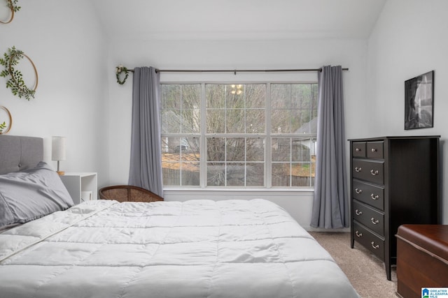 carpeted bedroom featuring vaulted ceiling