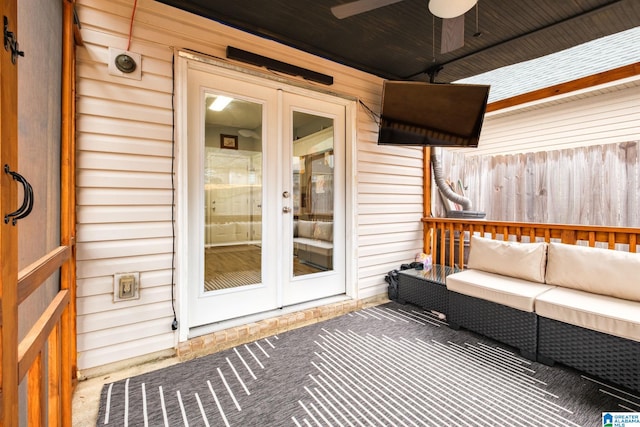 wooden terrace with french doors, ceiling fan, and an outdoor hangout area