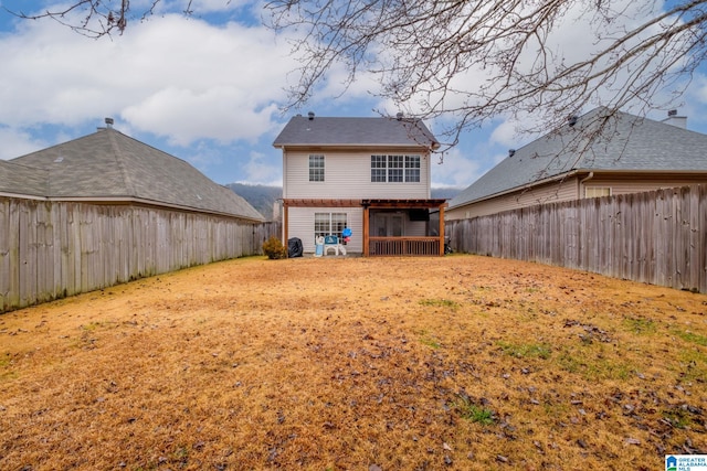 rear view of property with a yard