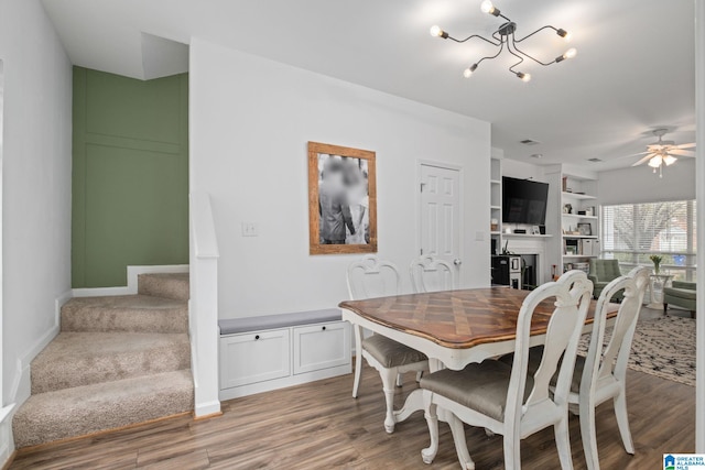 dining space featuring built in features, light hardwood / wood-style floors, and ceiling fan