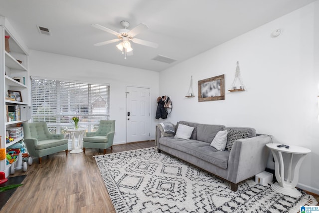 living room featuring hardwood / wood-style floors and ceiling fan