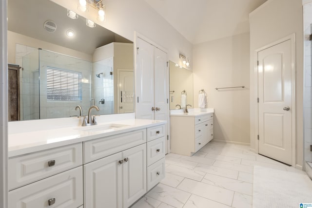 bathroom featuring vanity and a shower with door