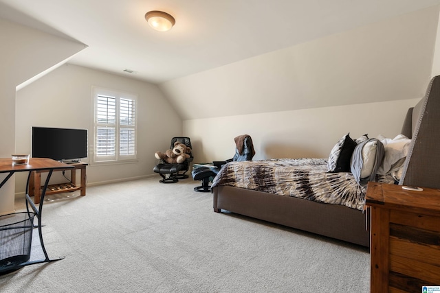 bedroom with lofted ceiling and carpet