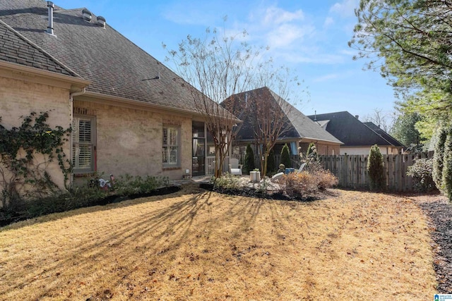 back of house with a lawn