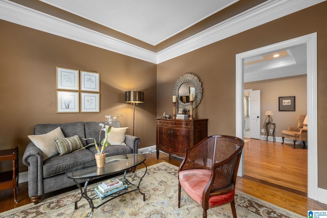 living room with hardwood / wood-style flooring and crown molding