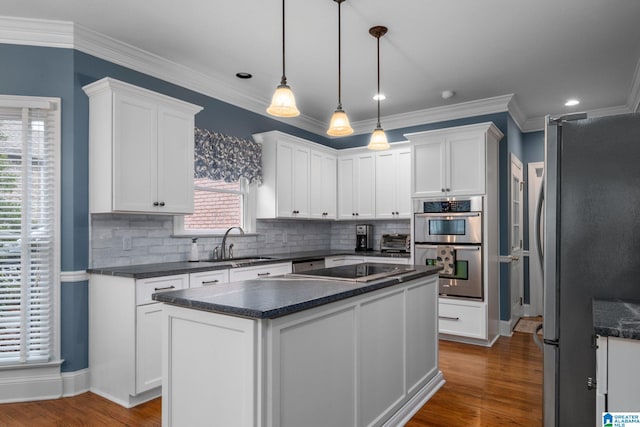 kitchen featuring white cabinetry, stainless steel appliances, and a center island