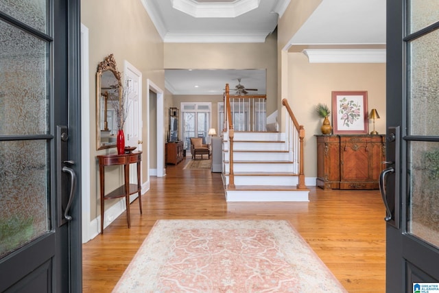 foyer with hardwood / wood-style floors and crown molding