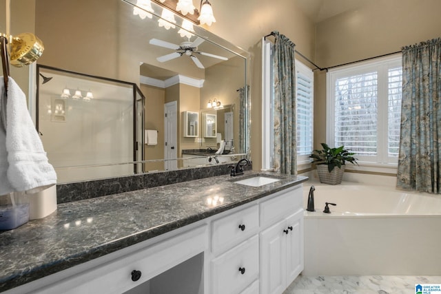 bathroom with vanity, ceiling fan, ornamental molding, and a bathing tub