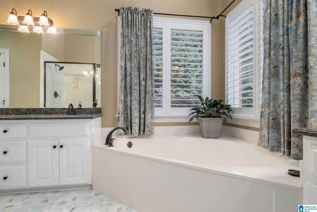 bathroom featuring vanity, a wealth of natural light, and shower with separate bathtub