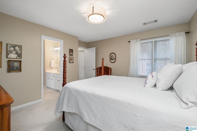 carpeted bedroom featuring ensuite bath