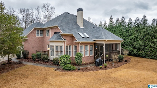 rear view of property with a sunroom