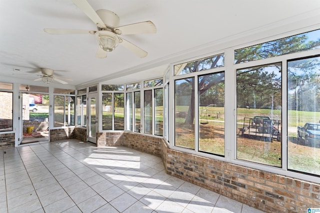 unfurnished sunroom featuring a wealth of natural light and ceiling fan