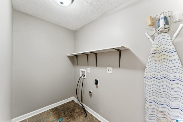 washroom featuring hookup for a washing machine, hookup for an electric dryer, and a textured ceiling