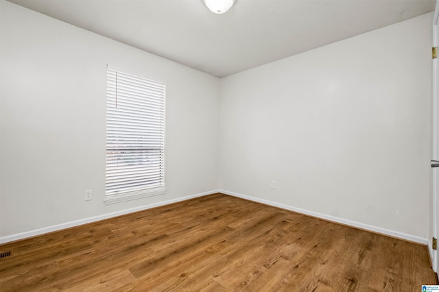 unfurnished room featuring wood-type flooring